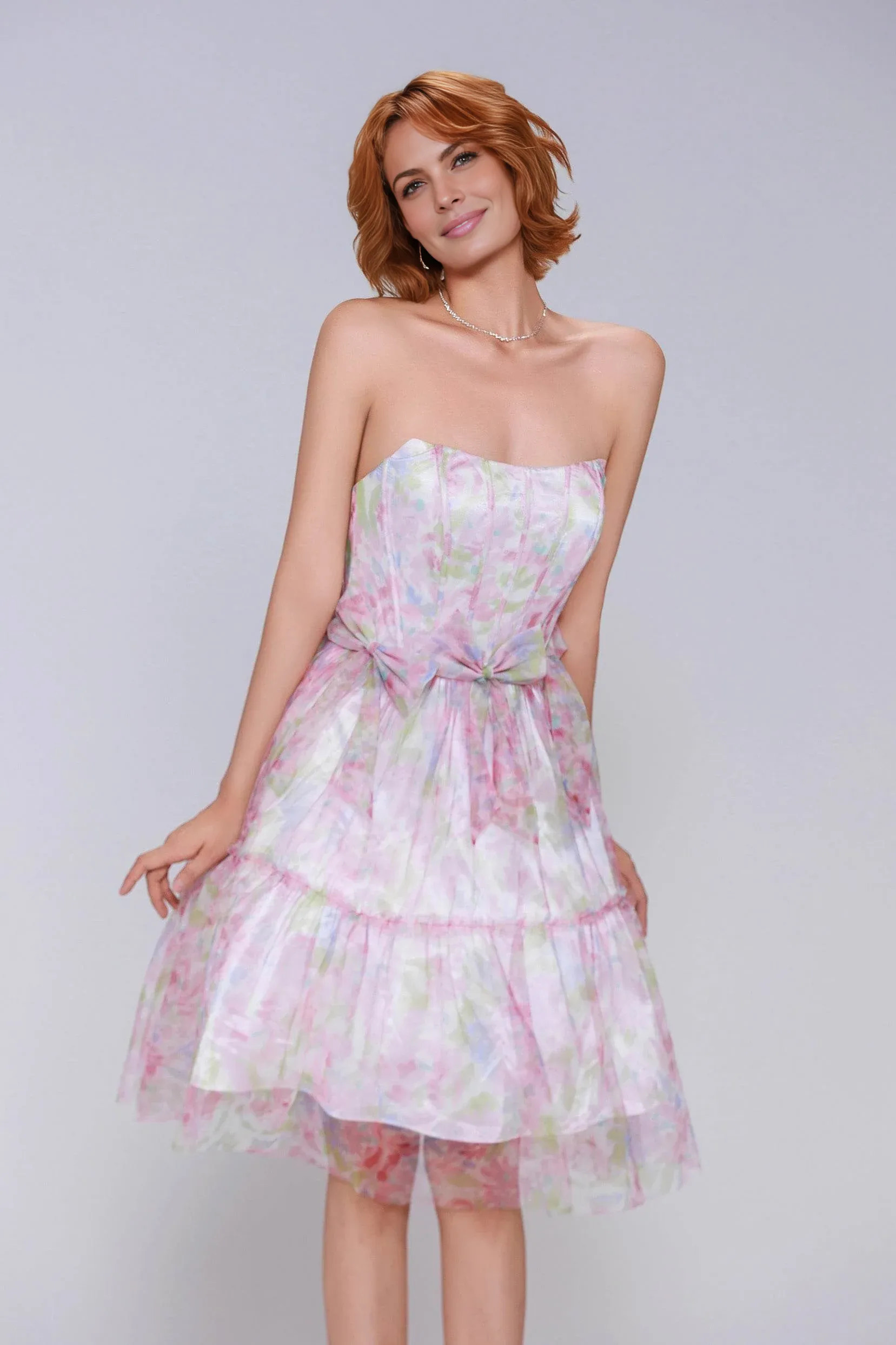strapless floral tulle homecoming dress with structured bodice, bow waist accents, and tiered A-line skirt