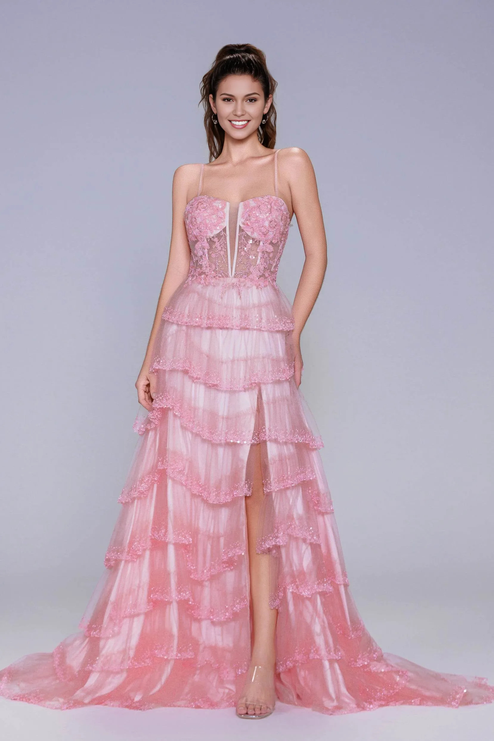 A-line evening gown with plunge neckline, spaghetti straps, appliqué illusion bodice, tiered tulle skirt, and front slit