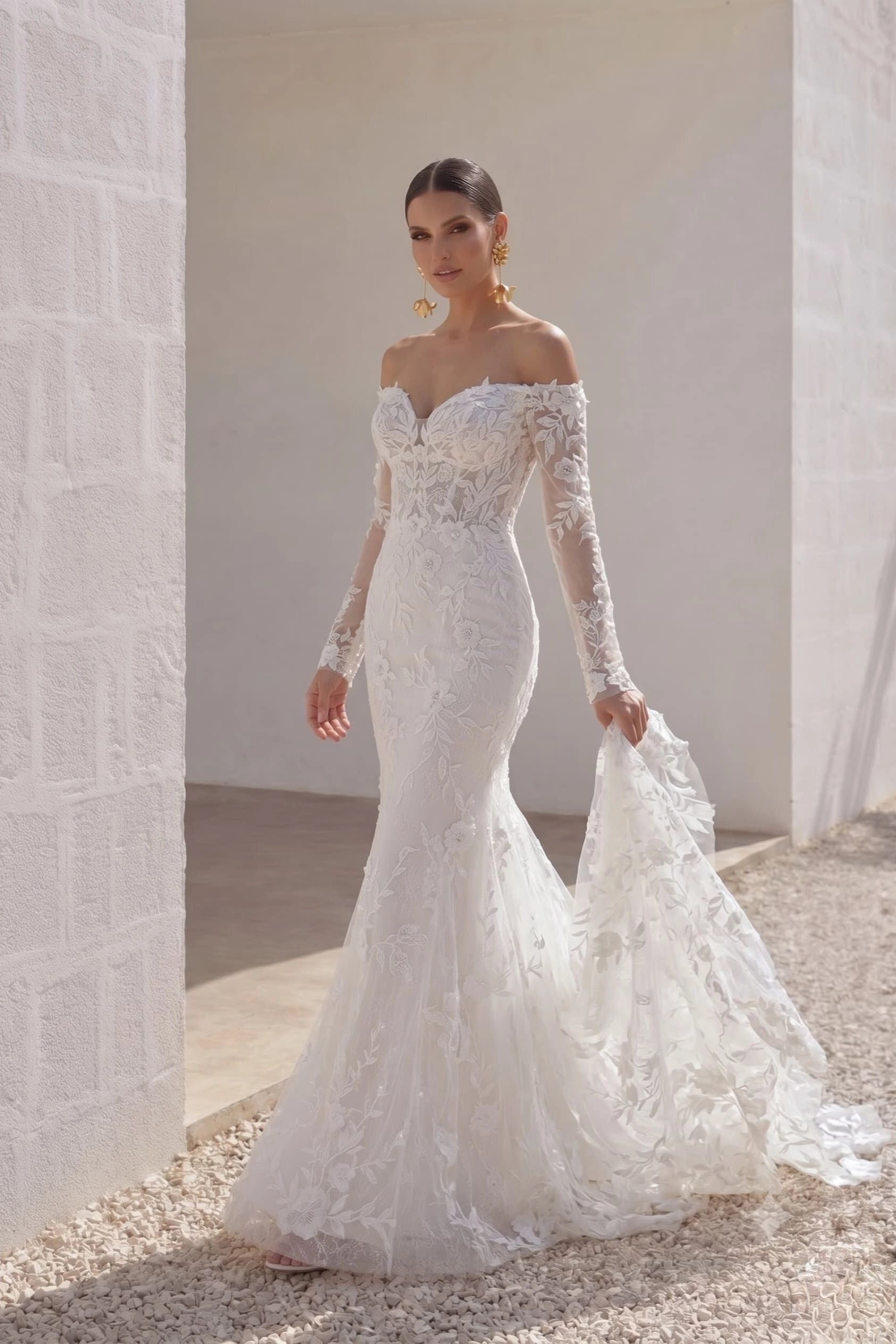 Vedress romantic 3d floral lace off shoulder long sleeve mermaid destination wedding dress stone wall front shot