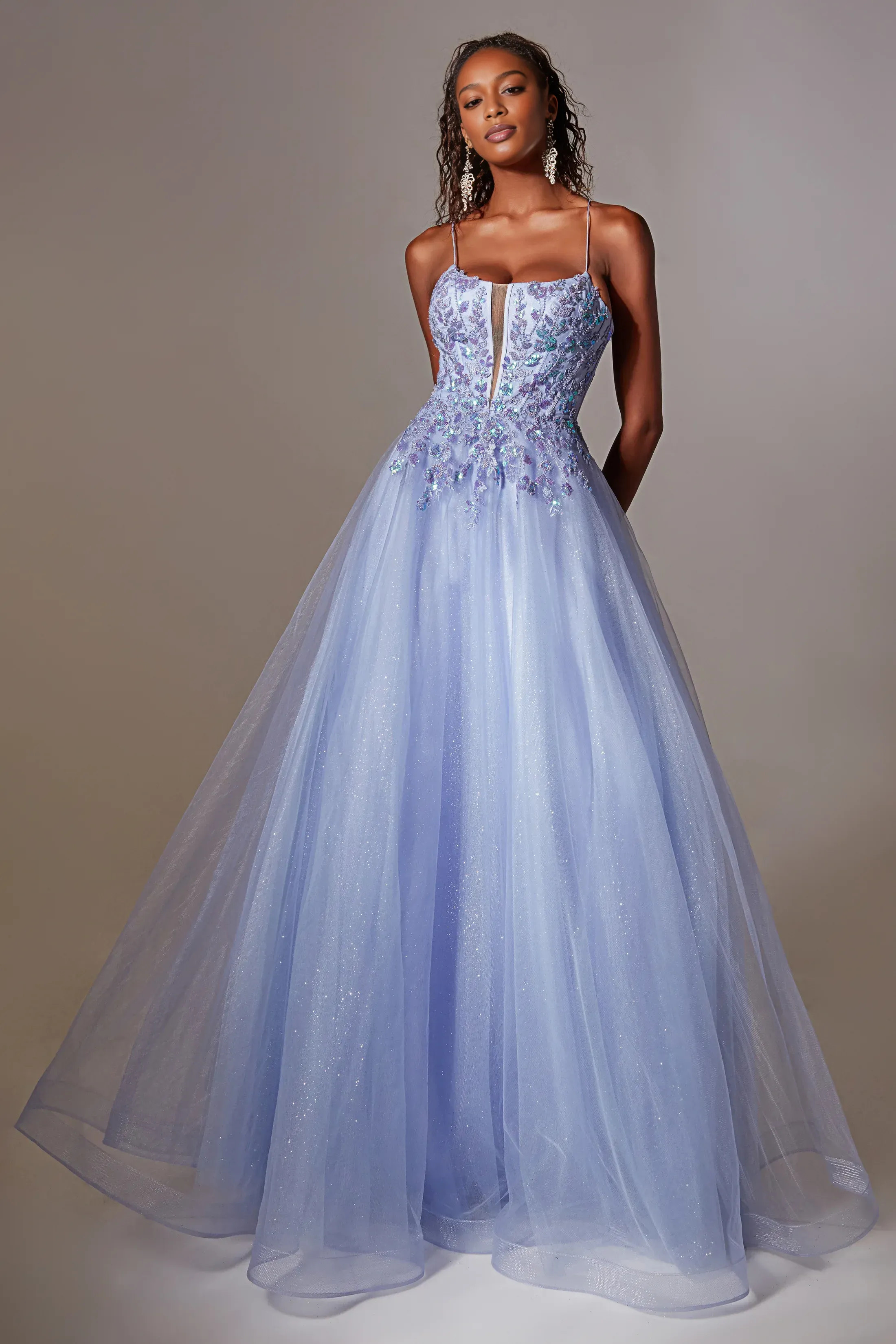 A-line plunging V-neck sleeveless tulle prom gown with embroidered applique bodice, sheer front inset, layered glitter skirt, and lace-up open back