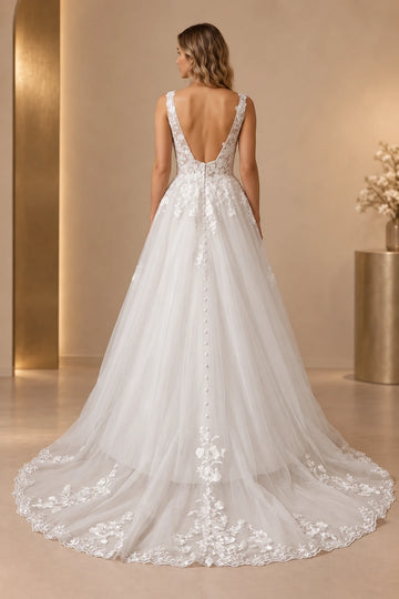 Back view of Vedress wedding dress with a deep open back, buttons extending down the skirt and a floral lace-edged train.