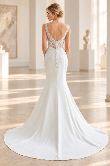 Back view of Vedress mermaid wedding dress with a low V-back, sheer floral lace, covered buttons and a sweeping train.
