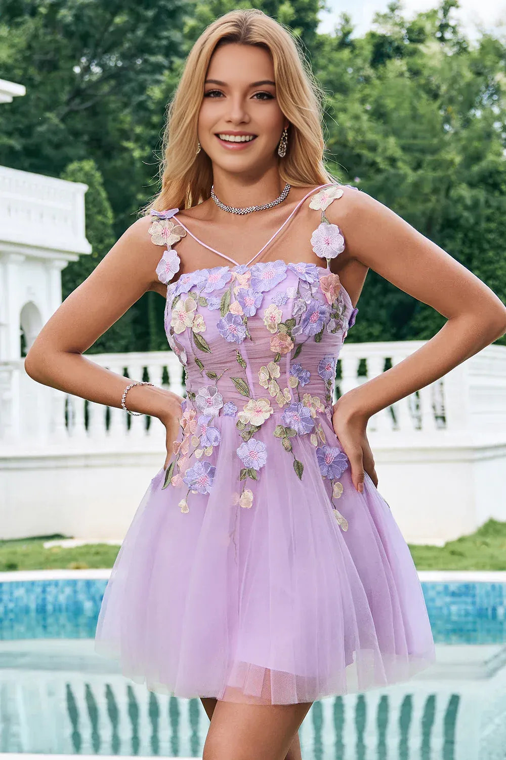 A-line tulle homecoming dress with straight neckline, floral appliqué bodice, and lace-up back