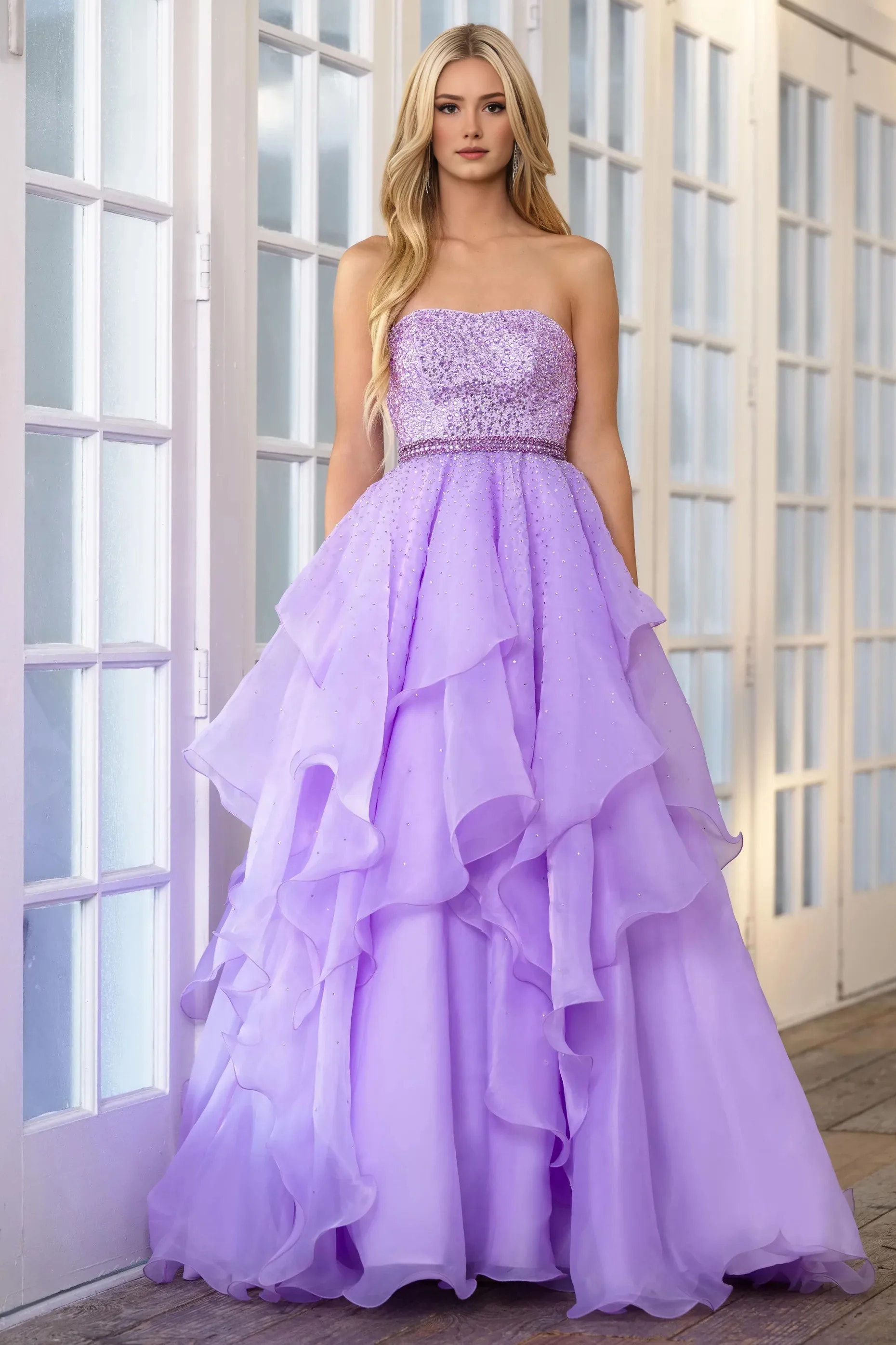 Dreamy A-line prom gown with strapless fully beaded bodice, embellished waistband, layered ruffled tulle skirt and scattered rhinestone details
