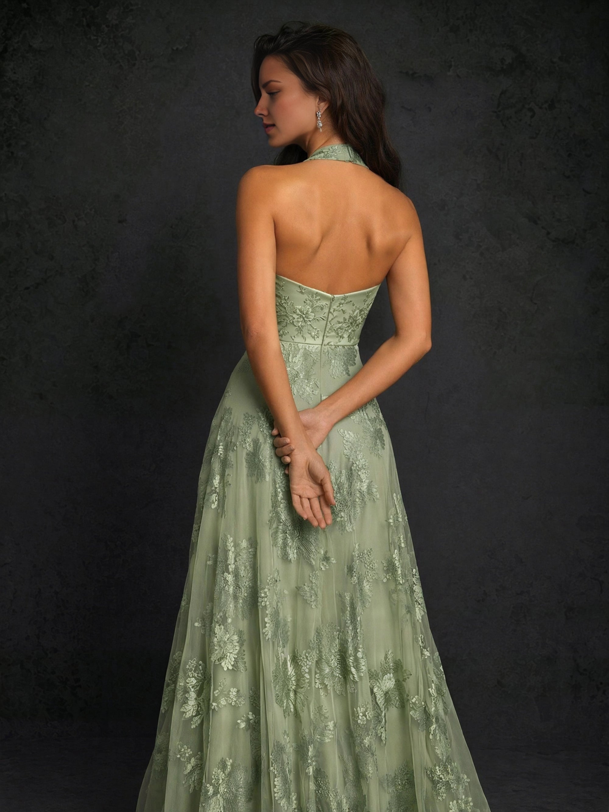 Sage green floor-length Wedding Guest Dress with halter neck, open back, and floral details