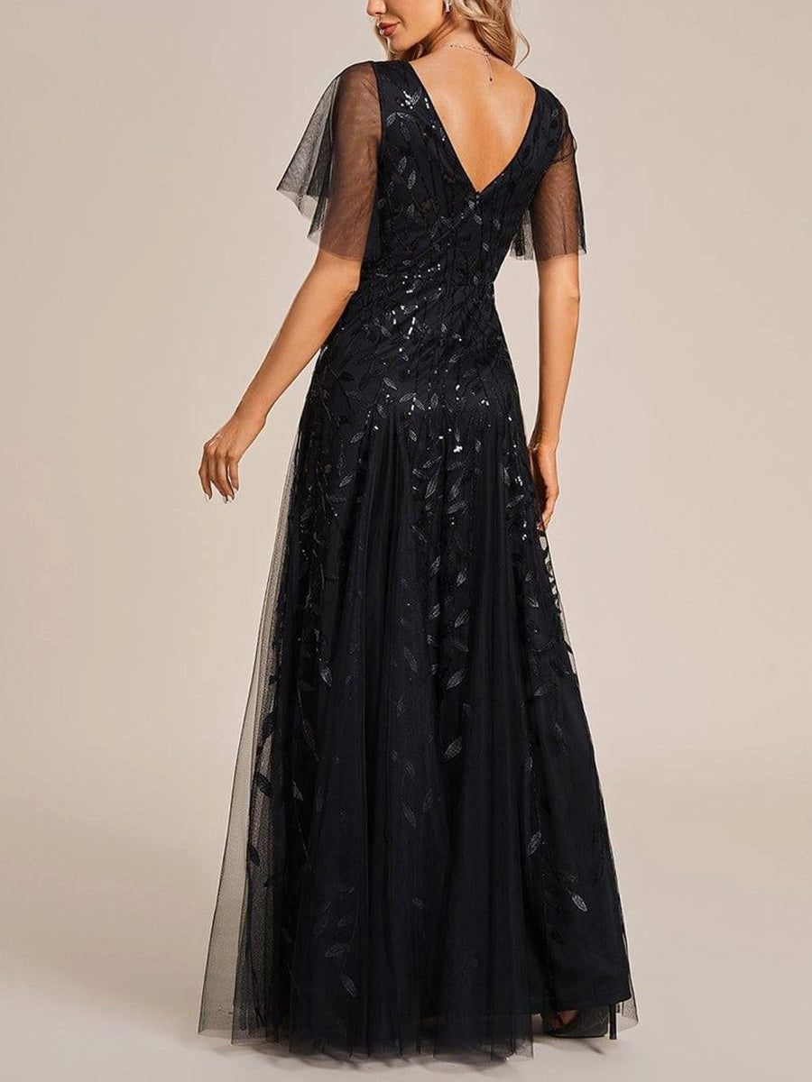 Vedress navy sequin formal gown back view,deep V‑shaped open back,invisible zipper,full‑length layered tulle skirt,neutral beige backdrop