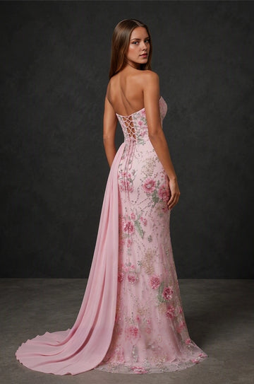 Blush pink formal dress with open lace-up back, floral embellishments, and long train