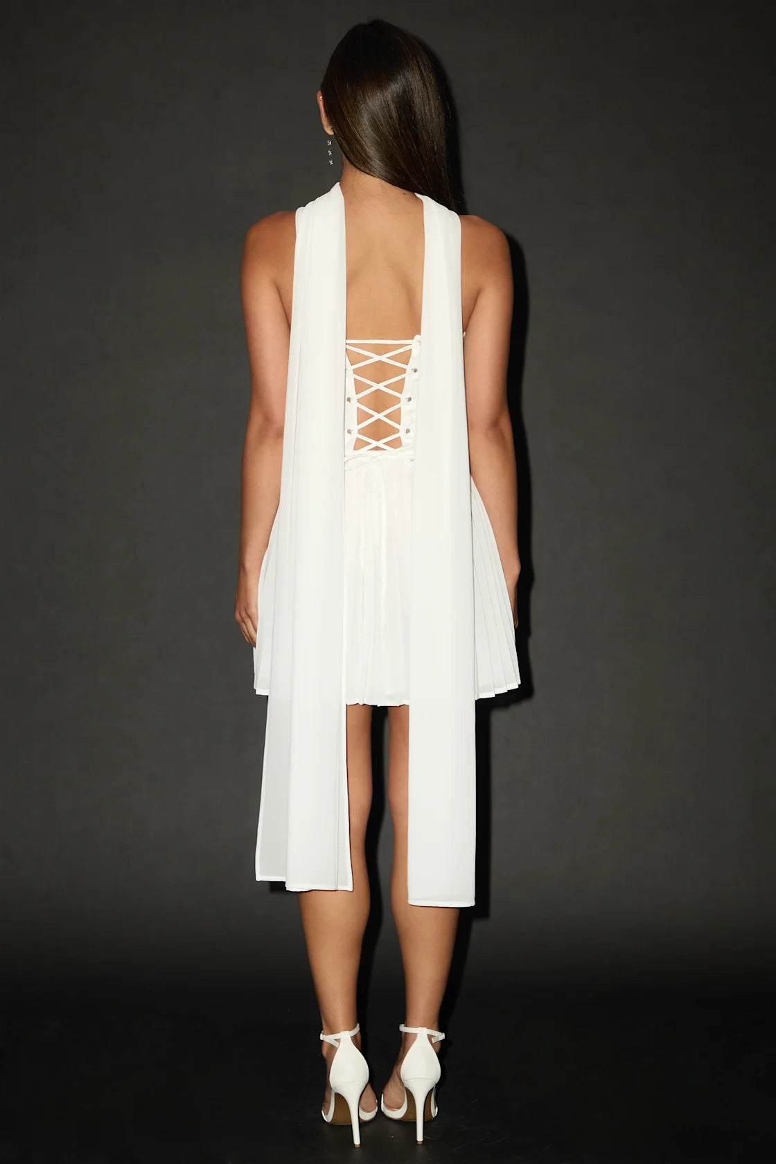 Back view of Vedress white strapless mini dress with corset lace up open back and long hanging chiffon sash fo