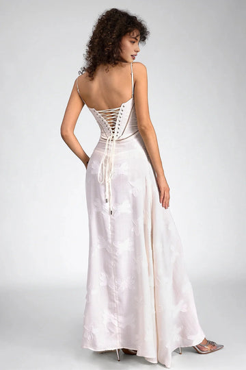 Back view of ivory wedding guest dress with spaghetti straps, lace-up corset and floor-length A-line skirt