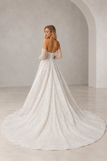 Back view of Vedress sparkling A-line wedding dress showing a low corset-style back, embellished sleevelets and a wide sweeping train.