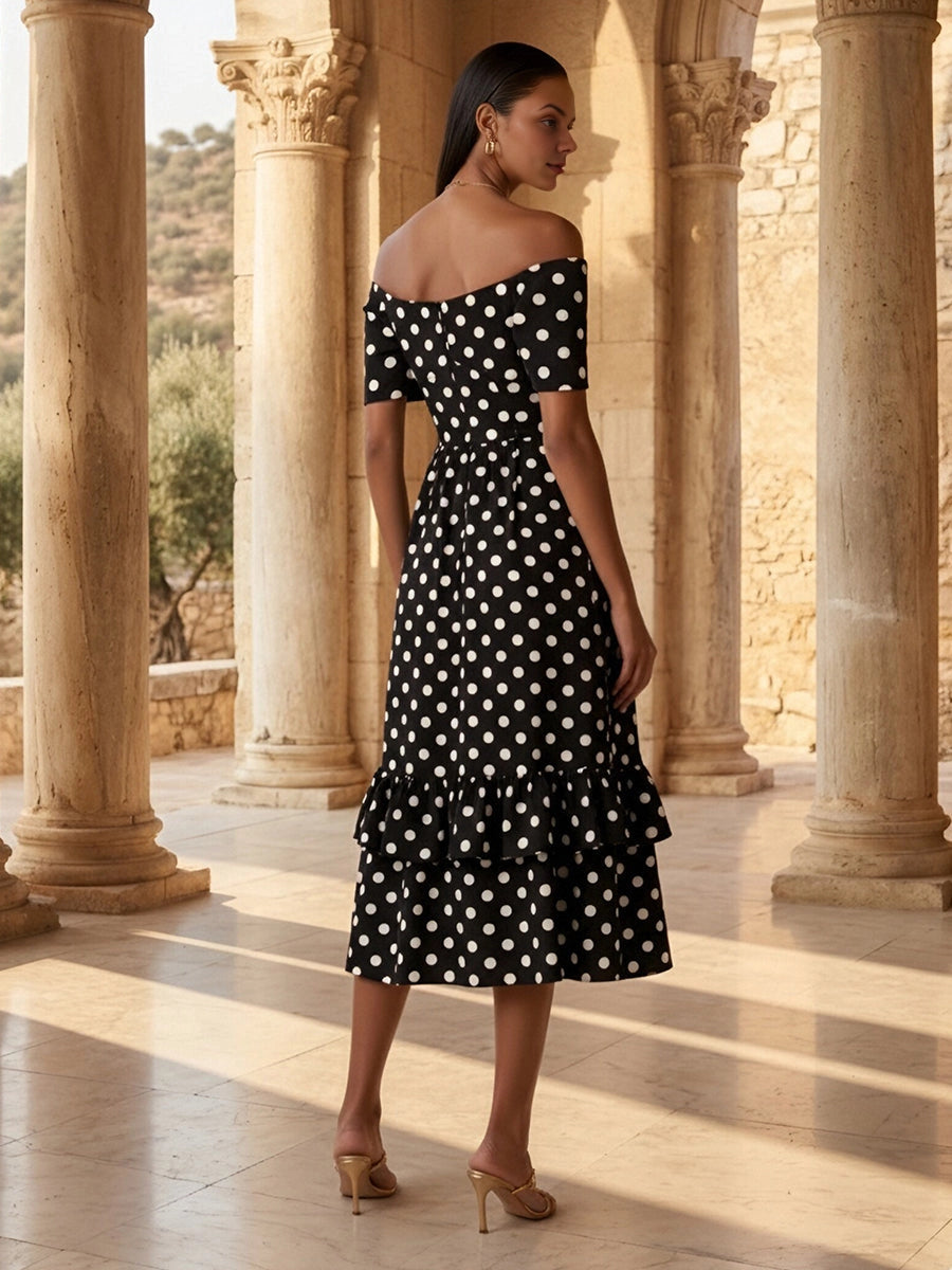 Model wearing vedress black polka dot off shoulder midi dress invisible zip back ruffled tier rear view