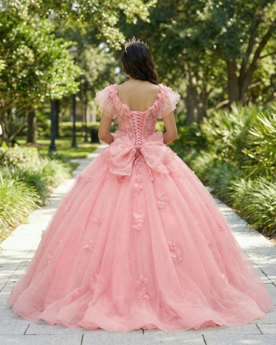 Vedress peach pink quinceanera ballgown back view, lace-up corset back with large tulle bow, floor length skirt decorated with 3D butterflies