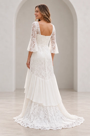 Vedress lace wedding dress with a low square back, central zipper, narrow waistband, cascading ruffle and sweep train, back view