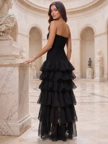 Back view of Vedress black strapless prom dress with a ruched bodice, center-back zipper, and cascading ruffle skirt.