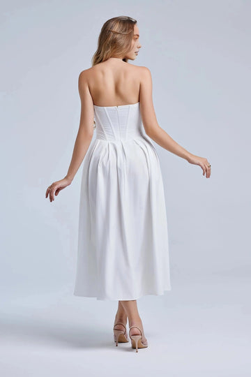 Back view of white strapless wedding guest dress with structured bodice, zipper back and ankle-length A-line skirt