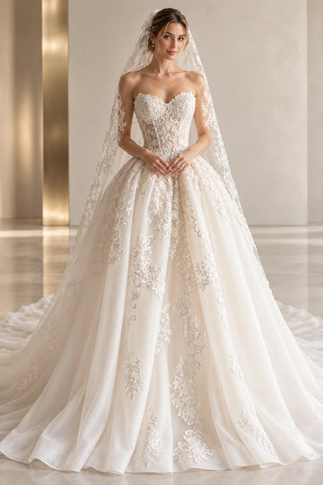 Vedress organza ball gown wedding dress with a strapless sweetheart neckline, sheer floral lace bodice and full applique skirt, styled with a veil.