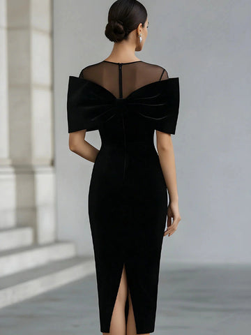 Back view of Vedress black mother of the bride dress showing a sheer upper-back panel, center-back zipper and back slit.