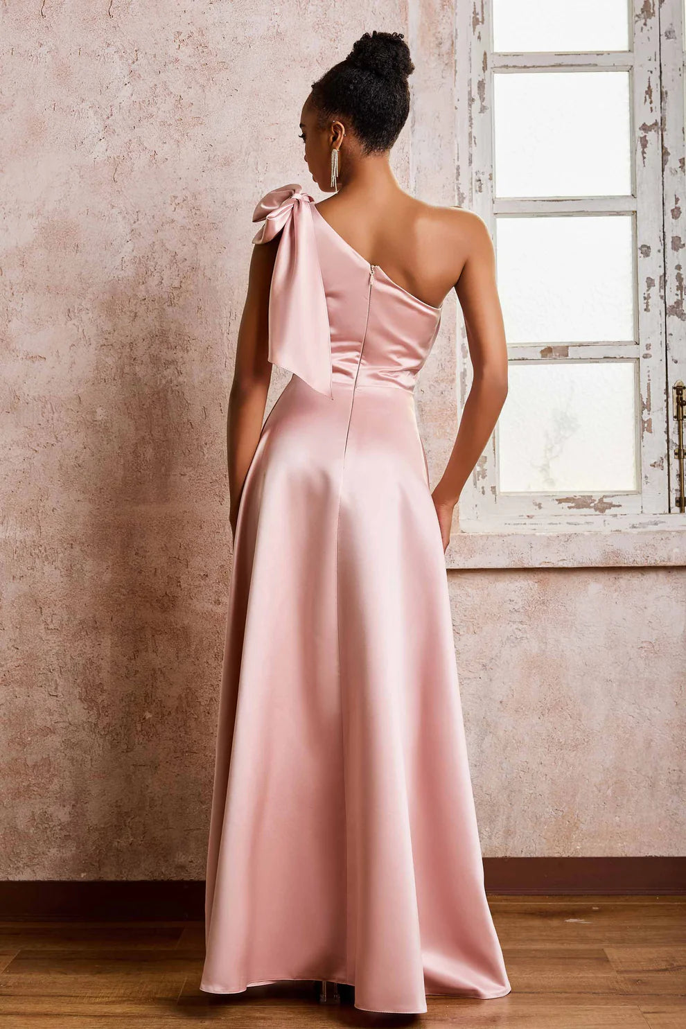 Blush pink satin formal maxi dress with asymmetric one shoulder back, bow detail, and zipper closure