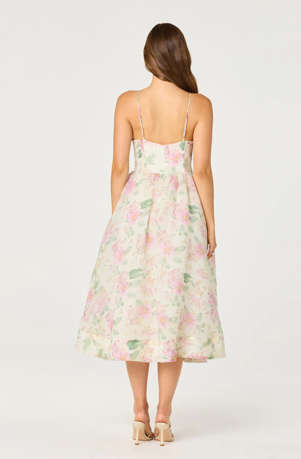 Back view of floral chiffon midi dress with spaghetti straps, smocked back panel, and flowing A-line skirt for garden parties