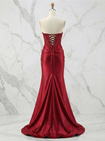 Vedress red satin prom dress with beaded back panels, crisscross corset lacing, and a flared sweep train, back view.