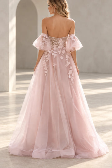 Back view of a Vedress blush pink wedding dress with a sheer floral lace bodice, off-the-shoulder puff sleeves and a floor-length tulle skirt.