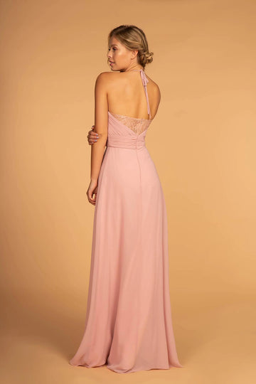 Back view of blush pink chiffon bridesmaid dress featuring a halter tie, sheer floral lace back panel, center zipper, and flowing A-line skirt.