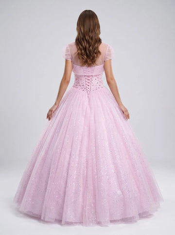 Blush pink floor‑length ball gown prom dress sweetheart heavily beaded bodice removable short puffed‑sleeve tulle shrug criss‑cross lace‑up back full sparkling glitter tulle skirt quinceanera gown by Vedress