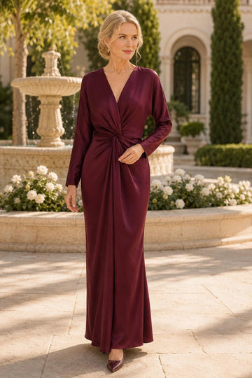 Burgundy sheath mother of the bride dress featuring deep V-neckline, long sleeves, center gathered waist and elegant floor-length skirt