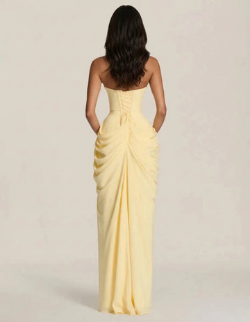 Back view butter yellow prom dress with corset lace-up closure ruched hips and floor-length skirt