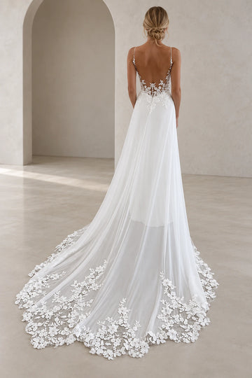 Back view of Vedress wedding dress featuring a deep scoop back, floral lace detailing, covered buttons and an extended sheer lace-edged train.