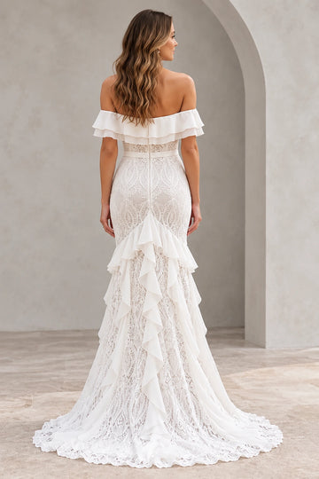 Vedress lace wedding dress with a low back, central zipper, cascading skirt ruffles and a scalloped lace train, back view