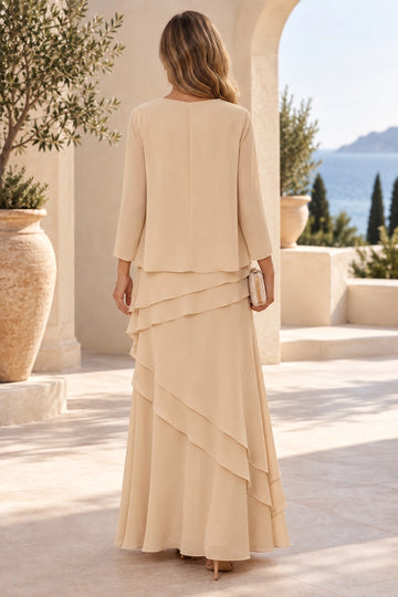 Back view of champagne mother of the bride dress featuring a matching open-front jacket, covered back and asymmetric layered ruffle skirt.