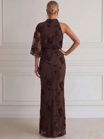 Back view of chocolate brown evening dress featuring floral embroidered mesh, asymmetric cape sleeve, concealed center zipper, and fitted floor-length silhouette.