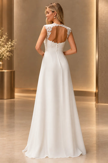 Back view of Vedress wedding dress featuring a large lace-framed keyhole back, center zipper and a flowing floor-length chiffon skirt.