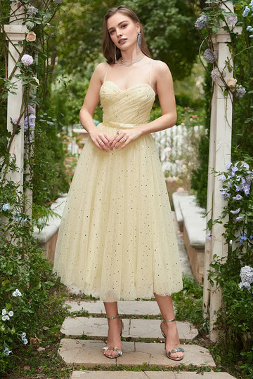A-line tulle homecoming dress with sweetheart neckline, spaghetti straps, star-glitter detail, and bow waist