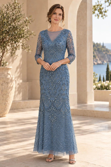 Dusty blue sheath mother of the bride dress featuring illusion V-neckline, sheer three-quarter sleeves, intricate floral beadwork and floor-length skirt