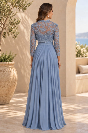 Back view of dusty blue mother of the bride dress with floral lace covered back, sheer three-quarter sleeves, ruched waist and flowing pleated skirt
