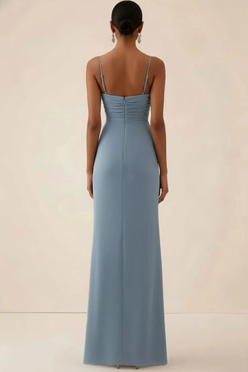 Back view of dusty blue bridesmaid dress featuring thin shoulder straps, horizontally ruched bodice, center-back zipper, and sleek floor-length sheath skirt.