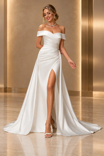 Vedress satin wedding dress with an off-shoulder sweetheart neckline, pleated bodice, fitted slit skirt and flowing overskirt, front view.
