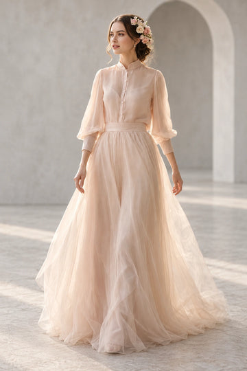 Front view of Vedress wedding dress with a stand collar, button-front chiffon bodice, sheer three-quarter sleeves and tulle A-line skirt.