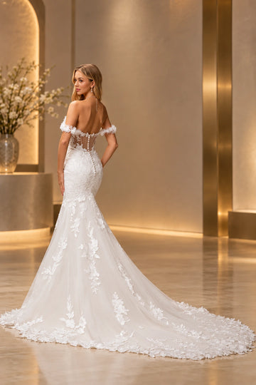 Back view of Vedress mermaid wedding dress with a low sheer button back, floral lace appliques and a sweeping lace-edged tulle train.