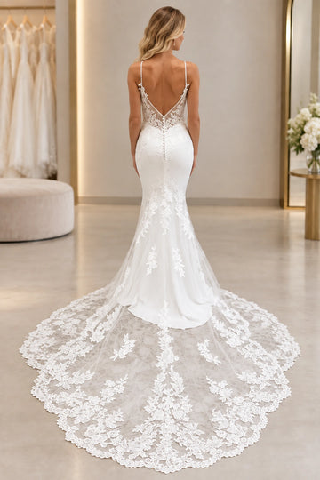 Back view of mermaid wedding dress with open back, covered buttons, and lace train