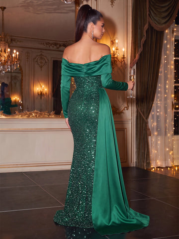 Back view of Vedress emerald green sequin evening dress with a folded back neckline, center zipper, and sweeping side drape.