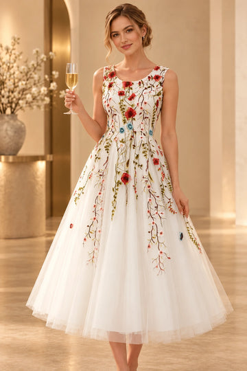 Front view of a Vedress ivory tulle wedding dress with colorful floral embroidery, a sleeveless scoop neckline and a tea-length A-line skirt