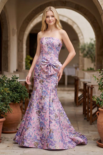 Front view of a floral mermaid prom dress with strapless neckline and statement waist bow