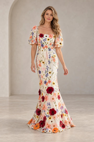 Front view of a Vedress floral mermaid wedding guest dress with colorful embroidery, a square neckline, short puff sleeves and dimensional flowers.