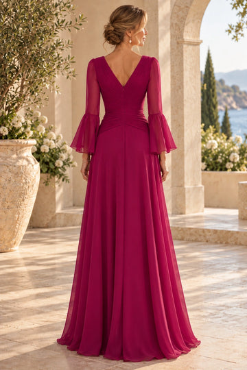 Back view of fuchsia mother of the bride dress with V-shaped neckline, center zipper, ruched waist, sheer bell sleeves and flowing A-line skirt