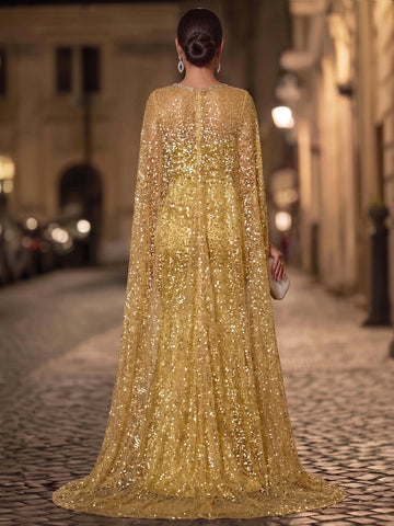 Back view of gold evening dress featuring a high-neck sheer sequin cape, flowing floor-length overlay, and elegant shimmering embellishments.