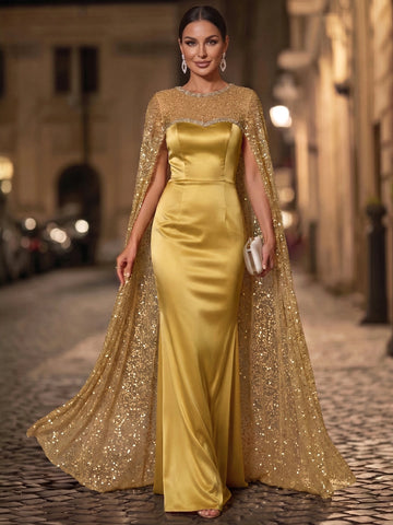 Gold sheath evening dress with a sweetheart satin-look bodice, fitted waist, floor-length skirt, and sparkling sequin cape by Vedress.