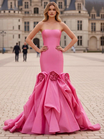 Hot pink strapless mermaid prom dress with sculptural rose accents and dramatic floor length skirt front view